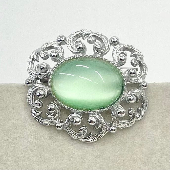 Vintage Silver Tone Mint Green Czech Glass Brooch with a Scrolled Filigree Surround TheGreenGlassGemShop