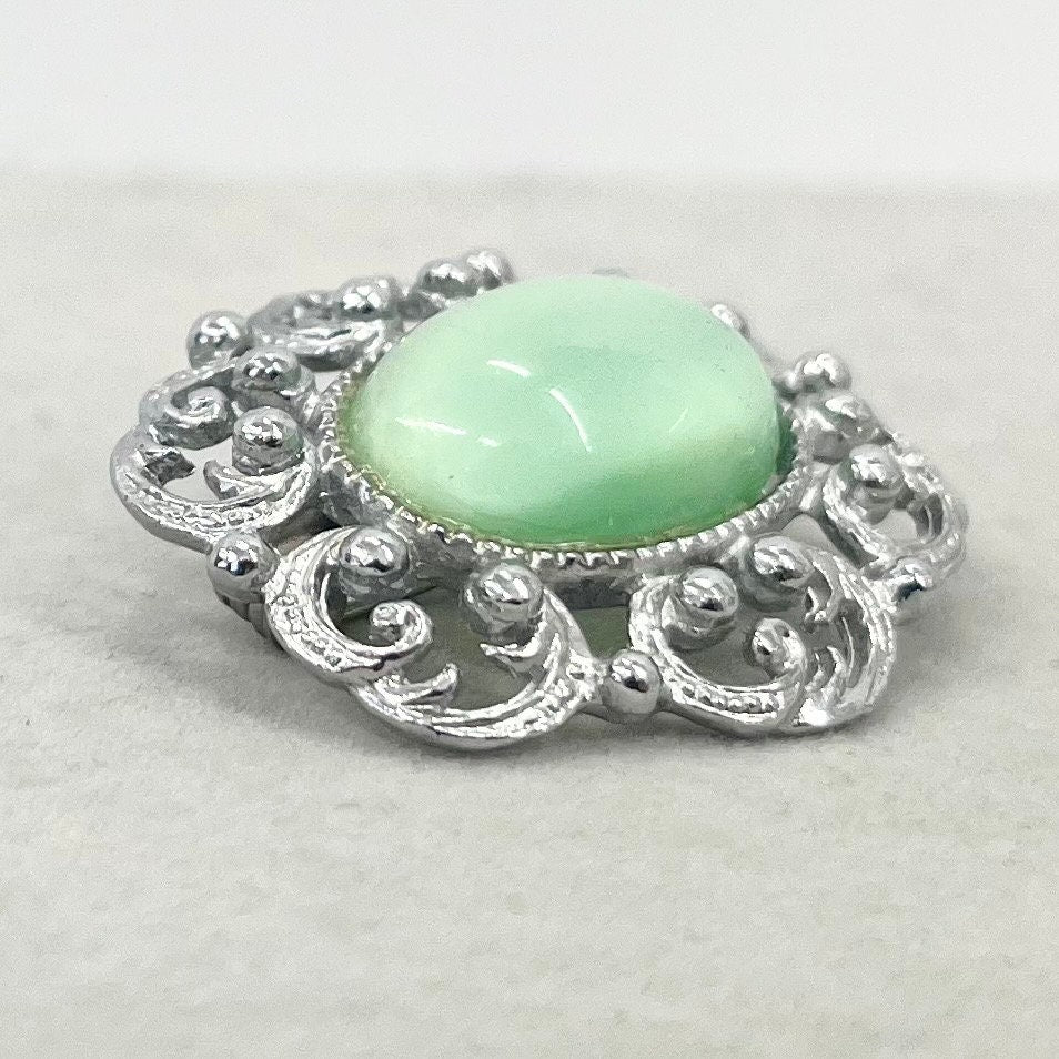 Vintage Silver Tone Mint Green Czech Glass Brooch with a Scrolled Filigree Surround TheGreenGlassGemShop