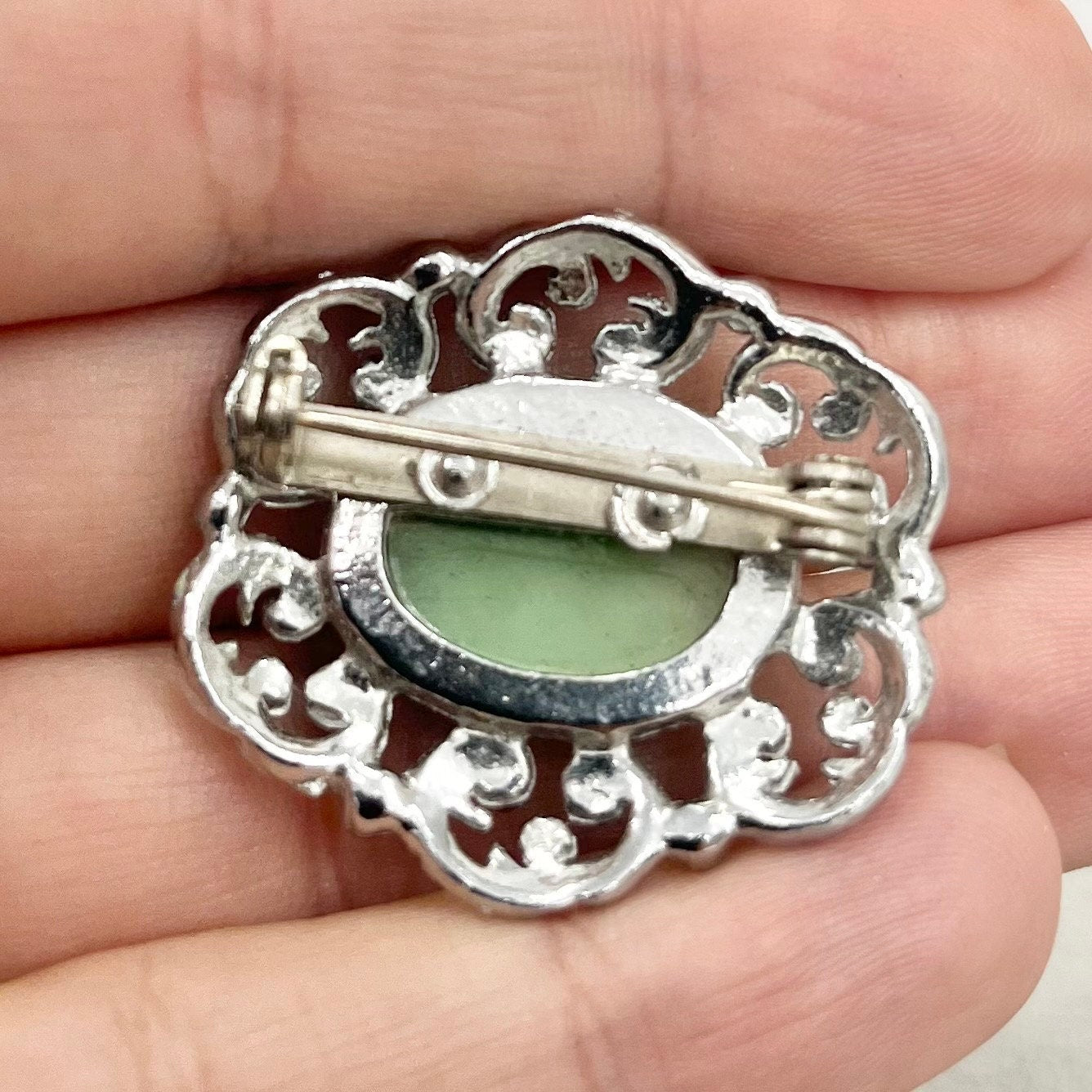 Vintage Silver Tone Mint Green Czech Glass Brooch with a Scrolled Filigree Surround TheGreenGlassGemShop